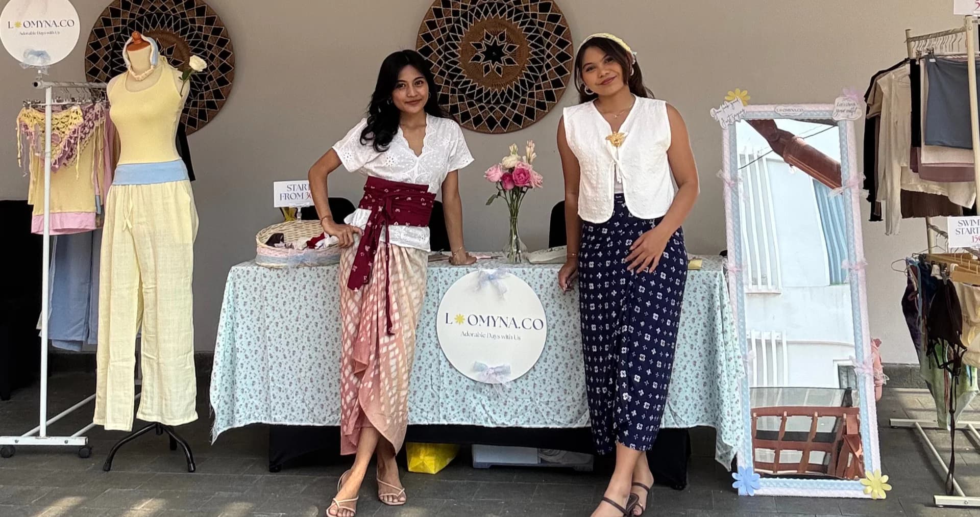 Two women by the sea wearing soft blue and butter yellow Loomyna tops