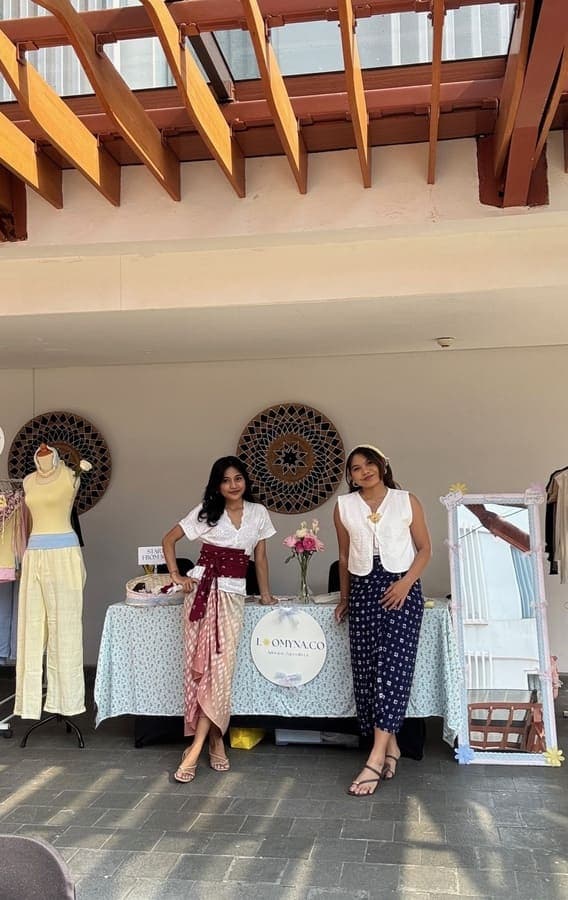 Two women by the sea wearing soft blue and butter yellow Loomyna tops